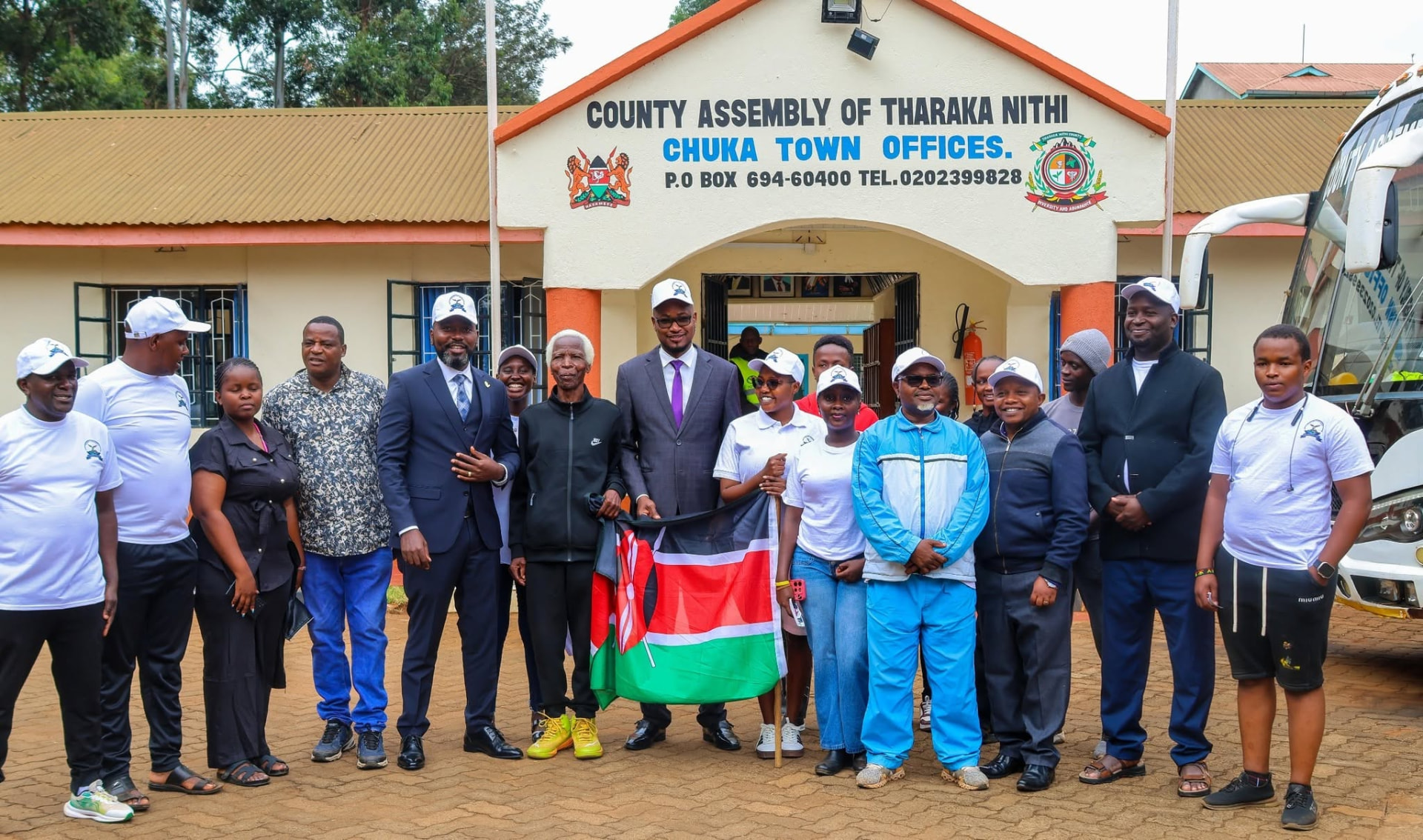 Assembly group outside the Chuka offices with the Kenyan flag